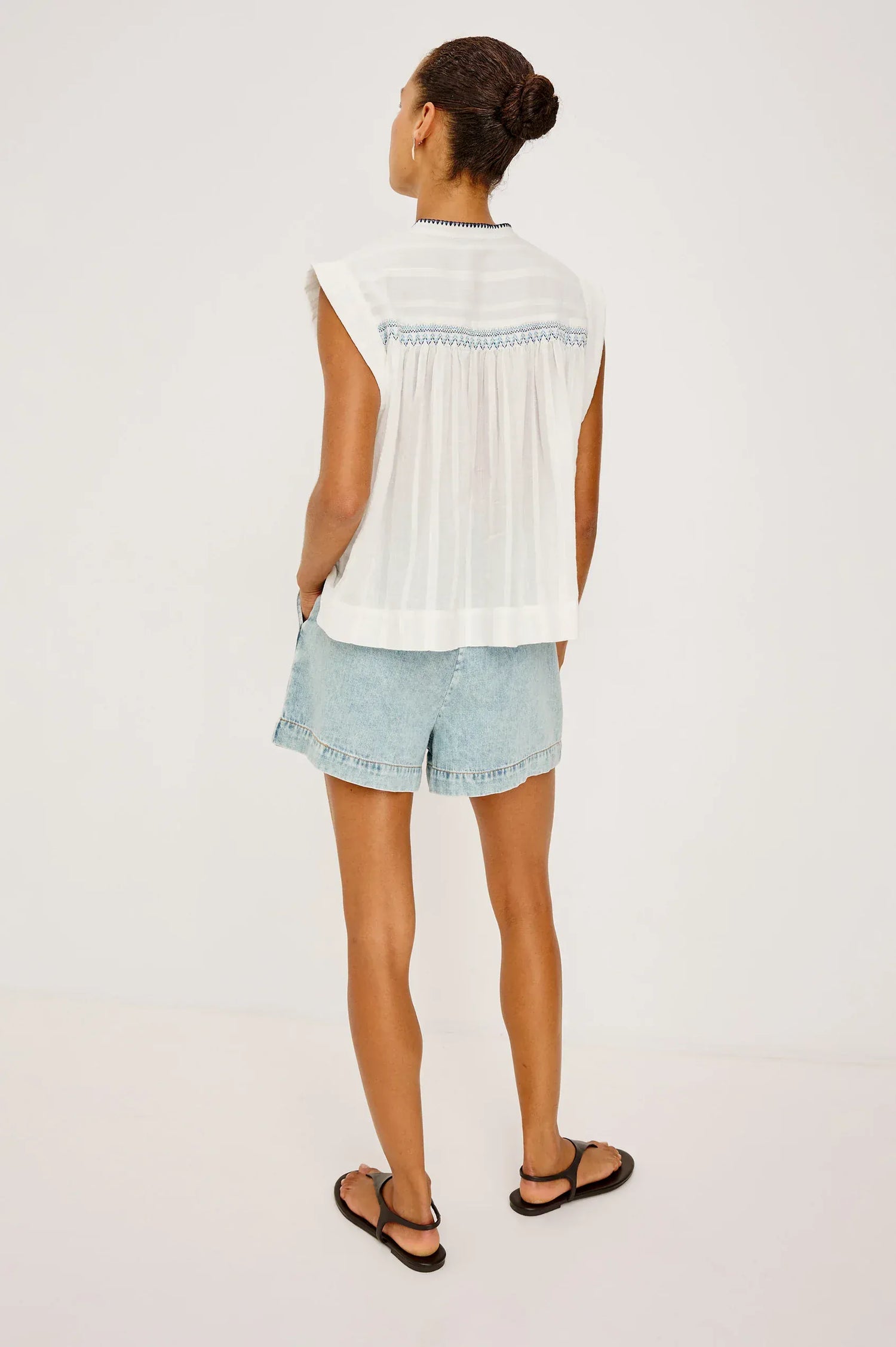 The Willow is a sleeveless trapeze-style top crafted from lightweight, subtly textured cotton. Effortless by design